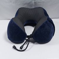 Front view of the U-shape neck pillow showing the adjustable black drawstring and combination of dark blue velvety fabric and black/gray mesh fabric.