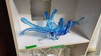 Blue MCM art glass centerpiece on shelf showing multiple extended arms and color gradient from light to dark blue.
