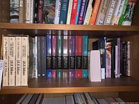 Shelf of books including Tolkien collection and Murdoch Mysteries