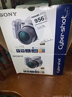 Sony Cyber-shot DSC-H9 camera box showing front with product image and key specs and branding.