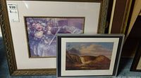 Photo showing both framed prints side by side, Montmorency Falls print in gold frame behind a floral-themed framed print, with the Harmonic Duet print partially visible.