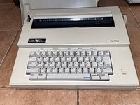 Front view of the beige Smith-Corona XL1000 electric typewriter showing the keyboard and maker's branding.