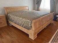 Angled view of king bed frame showing headboard, footboard and side rails