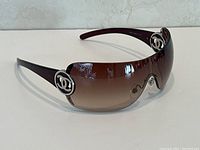 View of Chanel women's sunglasses showing frame and lenses with logo on side