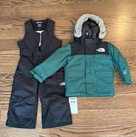 Complete toddler 2-piece winter snowsuit set laid out flat, showing jacket with hood and snow pants.