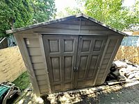 Front view showing double doors, latch, and pitched roof