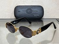 Full view of sunglasses with case in background
