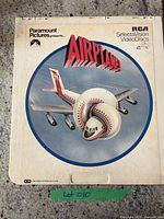 Front cover of Airplane! CED showing the airplane knot movie artwork, lot tag visible.