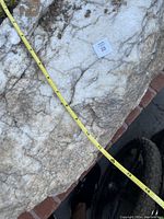 Photo of largest landscape rock showing white quartz surface with natural veining and measuring tape indicating approximately 37 inches in length.