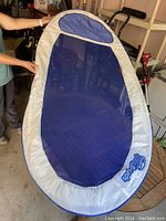 Blue mesh Spiral pool float shown held upright