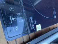 Close-up photo of the control panel showing Duxtop branding, touch buttons for function, power, lock, and temperature control on black induction cooktop.
