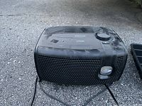 Bionaire Air Butler air purifier showing top control panel and ventilation areas, dusty and used condition.