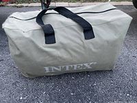 Beige carry bag with black handles labeled 'INTEX' on the side.