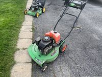 Full side view of the green Lawn-Boy commercial lawn mower showing the cutting deck, wheels, and handle setup.
