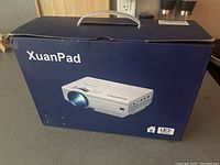 Box front showing XuanPad projector image, brand name, and LED marking.