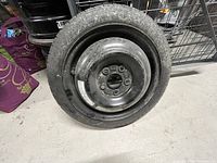 Side view of the full spare tire on steel wheel showing overall condition.
