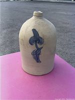 Front view of the stoneware crock jug, showing cobalt blue floral decoration on beige surface.