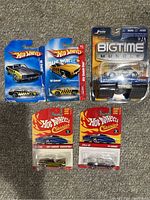 Photo of five diecast cars in original packaging: four Hot Wheels Classics and one Jada Bigtime Muscle Camaro.