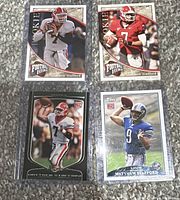 Four rookie football cards featuring Matthew Stafford in various uniforms and poses including Georgia Bulldogs, St. Louis Rams, and Detroit Lions.