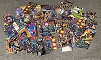 Overview image showing a large spread of over 80 comic books with varied colorful covers laid out on a carpeted floor.