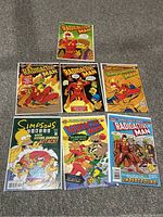 Seven Simpsons-themed comic books in protective bags, six being Radioactive Man comics and one Simpsons Comic issue 112.