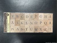 Photo of full wood stamp set showing all 27 pieces including letters A-Z and an exclamation mark.