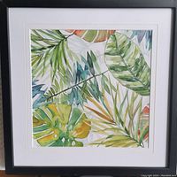 Frontal view of an original hand painted botanical artwork depicting various tropical green leaves in watercolor, custom framed with white double mats and black frame.