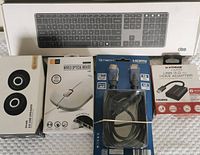 Photo of all items in original packaging: keyboard, mouse, HDMI cable, USB HDMI adapter, and speakers.