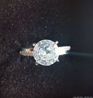 Top view showing round center diamond and accented band