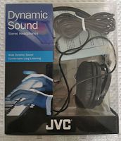 Front view of the JVC headphones in original packaging. Box shows damage but headphones and cable are visible and appear intact.