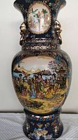 Full front view of the vase showing overall shape, cobalt blue ground and main court scene panel.