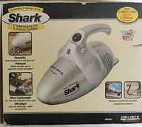 Front of Shark Turbo Hand Vac box showing vacuum cleaner, brand, model, features, and accessories