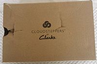 Cardboard shoe box with Cloudsteppers by Clarks branding