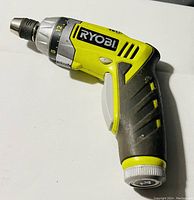 Ryobi cordless drill showing yellow and black body, adjustable torque settings, rubber grip and metal chuck