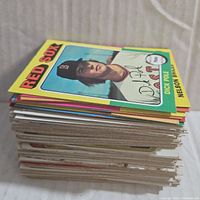 Stack of assorted vintage baseball cards with Red Sox card showing on top featuring Dick Pole.