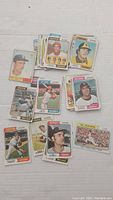 Top-down view of assorted vintage baseball cards with players from Boston Red Sox, California Angels, and others.