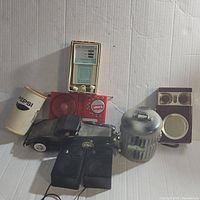 Overview photo showing all six novelty radios in the lot, detailing their unique shapes and branding.