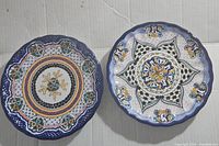 Both Talavera plates side-by-side showing top patterns and scalloped edges.