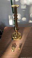 Large brass candlestick holder pictured alone with good lighting showing detailed shape and finish.