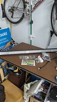 Full view of the long vehicle LED light bar with accessories on a table including wiring, mounting hardware, and switch.