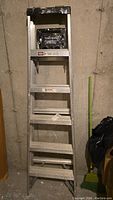 Full view of the Keller aluminum step ladder showing six steps and standing upright.