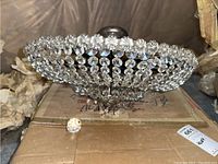 Top view showing the crystal beaded bowl shape of the chandelier with clear faceted beads and brass frame.