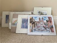 Full view of all six framed wall art prints arranged leaning against a wall.