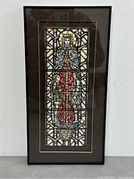 Full view of framed gouache artwork showing stained glass window depiction with saintly figure and children.
