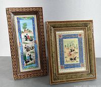 Two framed Persian miniature paintings standing side by side, showing detailed scenes of horse riding and traditional Persian borders, with decorative Khatam wood inlaid frames.