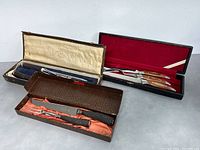 Three vintage cutting sets in original cases, showing all sets together.