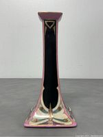 View of one side showing hand painted dragonfly design on pink background with black panel and gold accents.