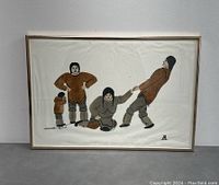 Framed signed stencil print showing the entire artwork with four Inuit figures in traditional clothing in a playful pose.