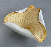 Triangular Murano glass bowl with white exterior and gold Venetian glass interior swirls and flecks, showing detailed top view.