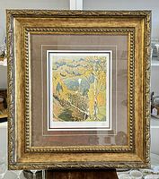 Full view of framed limited edition print 'October Gold' by Franklin Carmichael, showing ornate gold frame and triple matting.